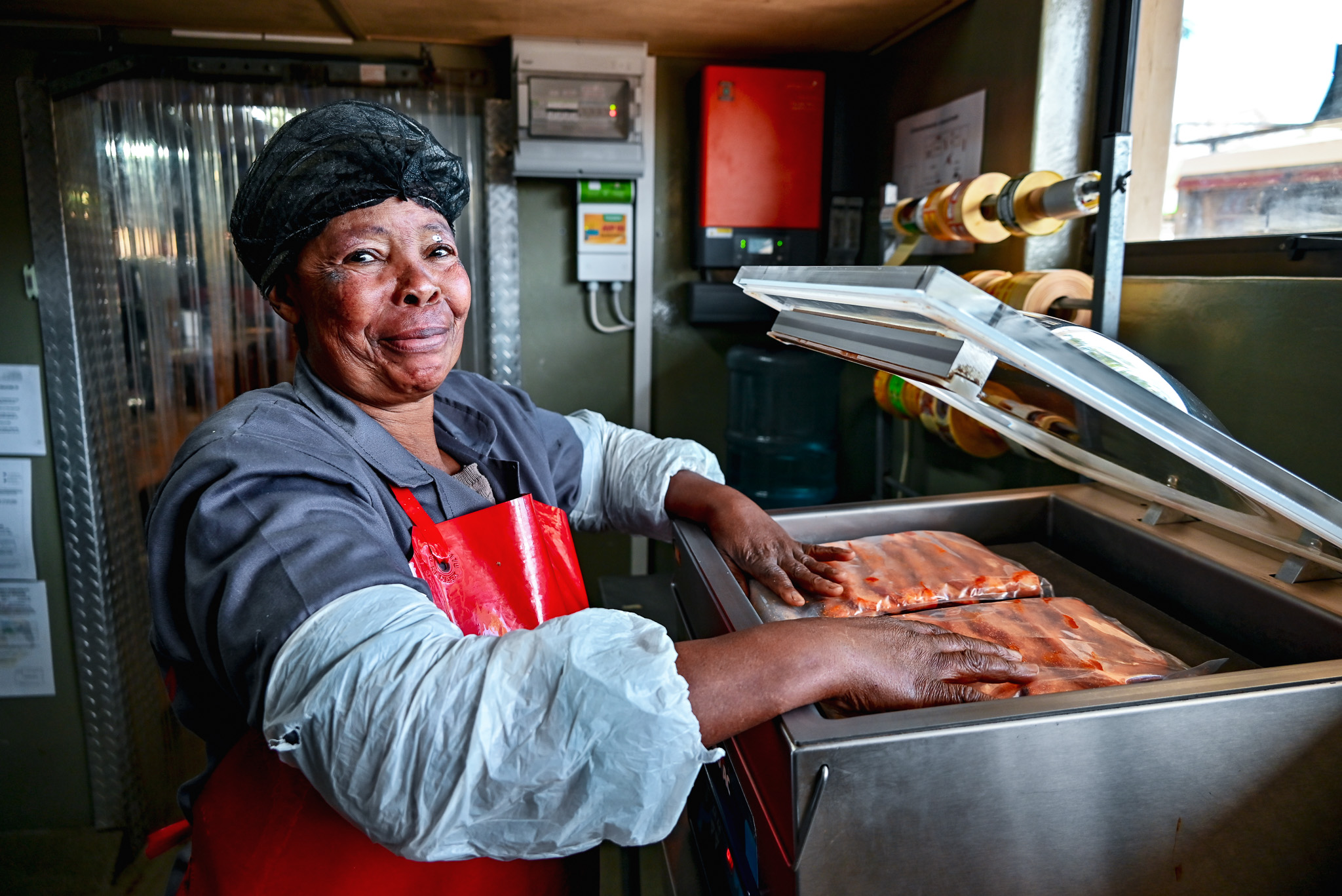 Natalia Meatmarket staff member vacuum-packing meat